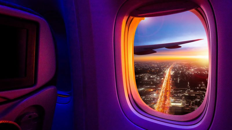 5387-airplane-porthole-window-overview-city-4k.jpg